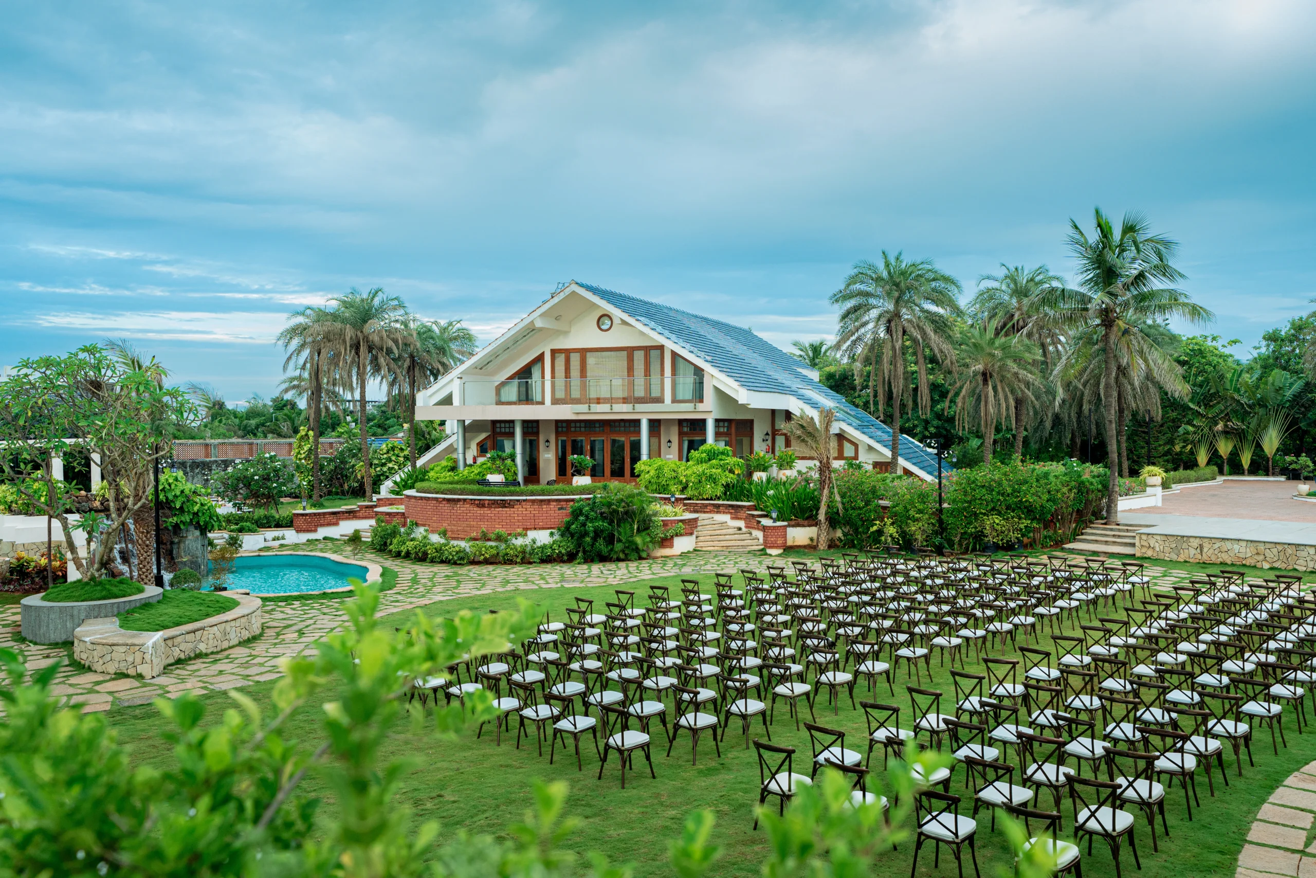 Elegant floral wedding aisle with mirrored walkway and luxury event décor