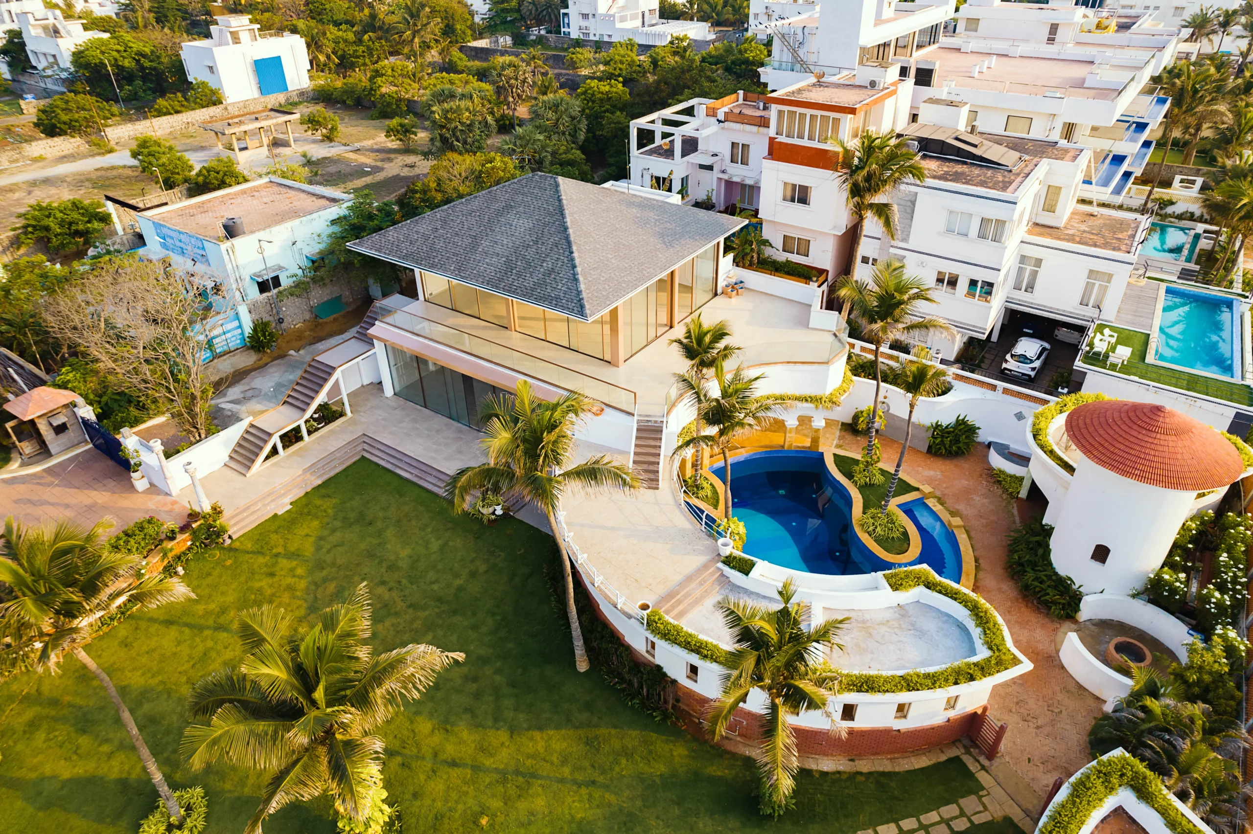 Beachfront villa overlooking the ocean with sunset views and open lawn